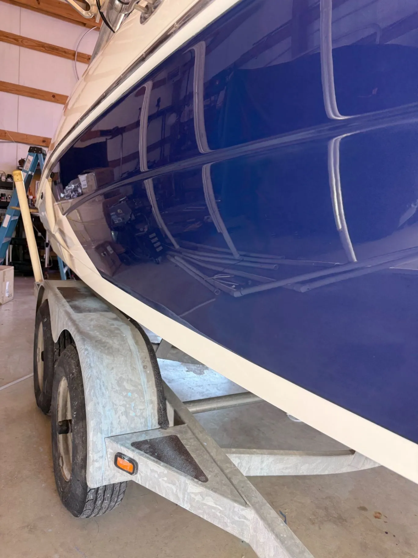 Yamaha boat hull after detailing, with a deep blue reflective finish