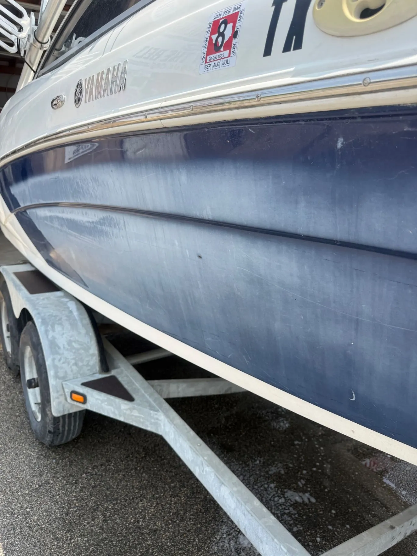 Yamaha boat hull before detailing, with a dull gray finish